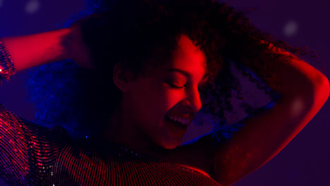 Close-Up-Of-Young-Woman-In-Nightclub-Bar-Or-Disco-Dancing-With-Sparkling-Lights-12
